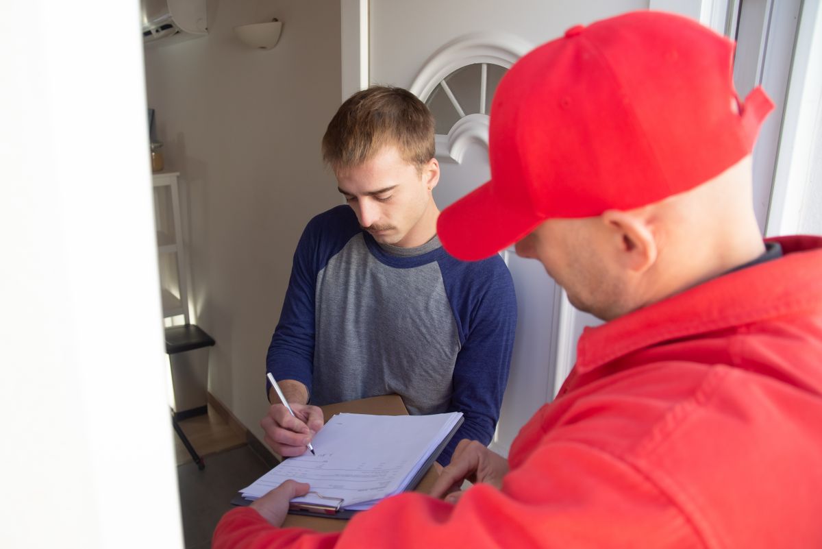Customer signing off with the technician at the door
